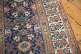 Traditional geometric border and repeating Veramin pattern on a hand knotted vintage Kurdish rug.