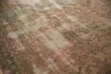 Distressed Oushak rug texture, showcasing its hard-worn pile and faded beige, green, blush.