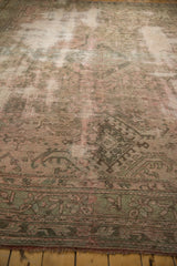 Distressed Oushak carpet with worn pile texture, moss green, blush, and border.