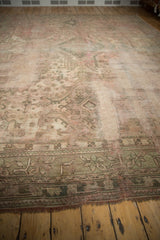 Hard-worn vintage Oushak rug pile, featuring a muted green border and secured fringe.