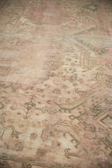 Close-up of the hard-worn Oushak pile, showing muted beige, green, and blush tones.