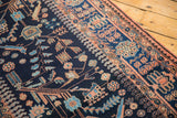 Delicate floral vinery and bird motifs in terracotta and blue on a navy vintage Mehreban runner.