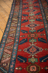 Northwest Persian runner detail: central quatrefoil bursting leaves, brick red, sky blue, and green tones.