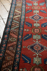 Vintage Northwest Persian runner's brick red field with sky blue quatrefoil motifs and border.