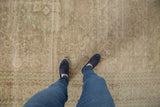 Distressed vintage Sivas rug with faded antique ivory and subtle seafoam floral patterns.