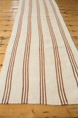 Close-up of the multi-banded stripes and fringed end of the vintage Turkish Kilim.