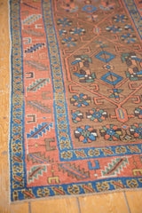 Madder root red border with serrated patterns, playful floral field of a Heriz rug.