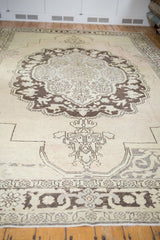 Distressed texture of vintage Oushak carpet showing chocolate brown and antique ivory.