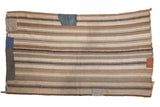 Vintage Moroccan Kilim carpet, horizontally striped in coffee brown, chocolate, and ivory with visible patches.