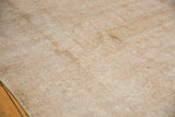Distressed texture and visible knot heads on a neutral vintage Sivas carpet.