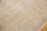 Vintage distressed Sivas carpet texture, revealing exposed knot heads and neutral tones.