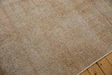 Distressed texture of the vintage Sivas carpet, showing even wear, knot heads, and analogous neutral tones.