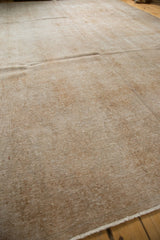 Textural surface of distressed vintage Sivas carpet, revealing faint designs in neutral tones.