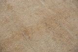 Distressed Sivas carpet texture with visible knot heads and subtle, neutral antique ivory and bronze tones.