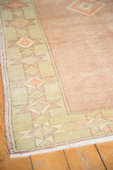 Pale seafoam green geometric border with cantaloupe starbursts, textured pale blush distressed Oushak.