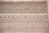 Detail of banded stripes with a geometric diamond lattice on a vintage Jijim runner.