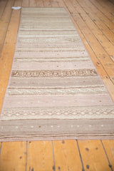 Angled view of the vintage Jijim runner, showing its full length and striped pattern in neutral tones.