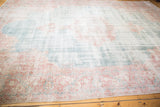 Worn texture of blush and rose border on a distressed ocean green Sparta rug.