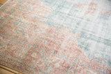 Distressed blush and ocean green curvilinear patterns with antique ivory tones on a vintage Sparta carpet.