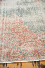 Distressed vintage Sparta carpet, showing soft blush, rose, ocean green, and ivory tones.
