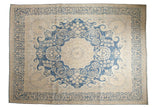 Vintage distressed Kerman carpet, indigo blue medallion, whimsical floral vinery, antique ivory field.