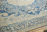 Distressed indigo blue and antique ivory floral vinery on a Kerman carpet.