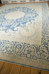 Distressed indigo blue floral vinery and border pattern on a vintage Kerman rug.