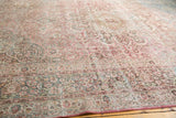 Distressed Meshed carpet border, displaying faded vinery and floral motifs in raspberry and dusty teal.