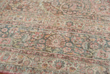 Distressed Meshed carpet's soft raspberry, teal, and ivory floral patterns with textured pile.