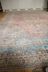 Distressed Persian Meshed carpet corner, dusty teal border, pale raspberry vinery, foundation wear.