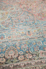 Distressed Meshed carpet detail with faded pale raspberry and dusty teal floral vinery.