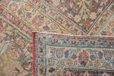 Distressed vintage Meshed carpet, worn pile revealing foundation and detailed floral border.