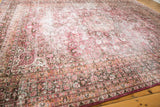 Distressed vintage Persian Meshed carpet texture, with fuscia and peach floral vinery.