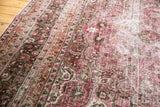 Artfully distressed fuscia and raspberry floral vinery on a vintage Persian Meshed carpet.