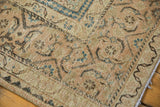 Distressed Mahal carpet corner showing isolated wear, faded copper, khaki, and blue tones.