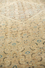 Vintage distressed Mahal carpet featuring muted khaki pile, indigo Herati and geometric medallion.