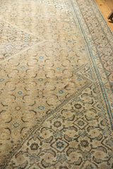 Distressed vintage Mahal rug displaying faded khaki, indigo blue Herati motifs.
