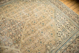 Distressed vintage Mahal carpet corner, displaying geometric border and faded Herati field.