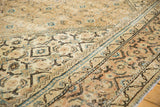 Distressed Mahal carpet, angled view of faded indigo and khaki geometric patterns.