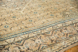 Close-up of distressed vintage Mahal rug, faded geometric border, indigo blue details.