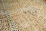 Faded copper khaki and indigo geometric Herati patterns on a distressed Vintage Mahal carpet.