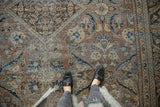 Textured pile of the distressed Mahal carpet, with faded floral designs in blue, brown, and sand tones.