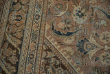 Distressed Mahal rug close-up showing worn floral elements, visible foundation, coffee brown, dark teal.