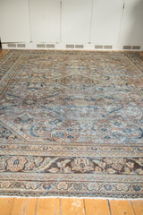 Distressed vintage Mahal carpet border, showing faded brown, beige, and blue floral motifs.