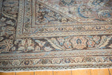 Distressed vintage Mahal rug corner, showing worn curvilinear floral motifs and classic border.
