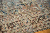 Distressed vintage Mahal carpet, worn pile and floral patterns in muted browns and teal.
