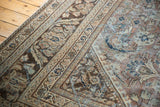 Distressed vintage Mahal carpet detail: worn coffee brown, teal floral design, and intricate borders.
