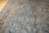 Distressed vintage Mahal rug with European-Persian floral motifs in soft brown, beige, and blue.