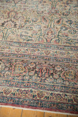 Distressed Khorassan rug border and field with palmettes, vinery, soft ivory, madder red, and blue tones.