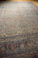 Vintage distressed Khorassan carpet border with navy blue, brick red, and faded palmette motifs.